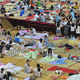 College students sitting on bamboo/straw mats at a air-conditioned school gym to escape the sweltering heat in their dorms, which are not air-conditioned, in Wuhan, central Chinas Hubei province, 21 June 2013. Temperatures in half of China hit 35 Celsius (95 F). In Wuhan, one of the three hot pots along the Yangtze River, temperature soared to as high as 39 C, with very high humidity. Chinese college dorms, which are mostly not air-conditioned, are the worst-hit. Having no AC at their dorms, students at Wuhan-based Central China Normal University had to sleep on bamboo/straw mats in the air-conditioned school gym during the night to escape the summer heat.(Imaginechina via AP Images